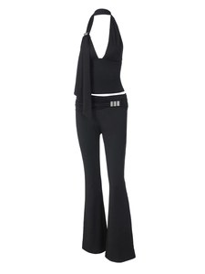 Detail of black halter top and flare pants set with metal buckles and long straps