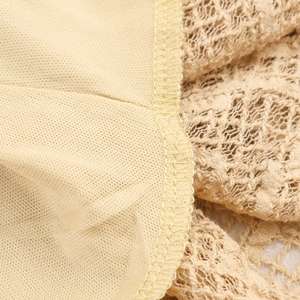 Beige knit long-sleeve maxi dress showing high-quality lace and fabric stitching detail