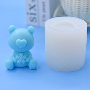 Detail of light blue bear silicone mold and finished heart bear craft for DIY baking