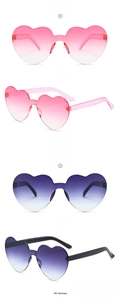 Detail of rimless heart-shaped sunglasses in gradient pink and grey colors