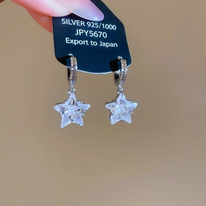 Detailed close-up of a 925 silver star earring with brilliant cubic zirconia stones