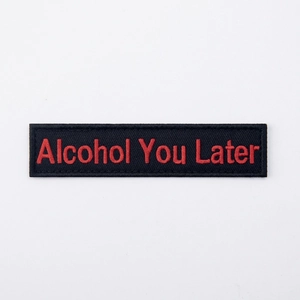 Detailed view of Alcohol You Later rectangular embroidered patch with red text on black