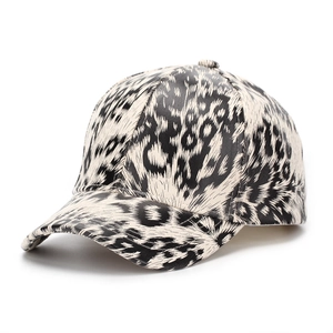 Detail of classic black and white leopard print baseball cap with faux leather texture