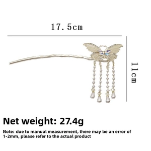Detail of silver butterfly hair pin featuring purple rhinestones and pearl tassels