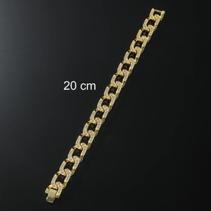 Close-up of a 20cm gold plated iced out Cuban link anklet for men with crystal details