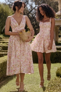 Detail of floral print summer midi dress fabric in a sunlit garden setting