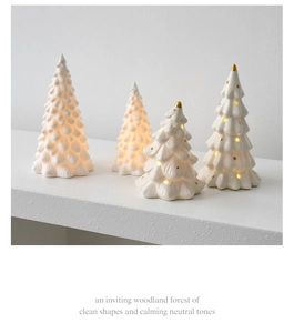 Set of four ceramic Christmas trees with gold dots and warm LED glowing internal lights