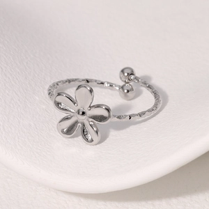 Minimalist flower ring with textured silver band and adjustable open design