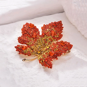 Exquisite maple leaf brooch with orange crystals and rhinestones in golden setting