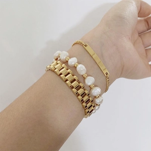 Three-piece gold link bracelet set with baroque pearls and rectangular metal charm