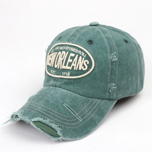 Detailed macro of vintage washed green baseball cap with distressed embroidery detail