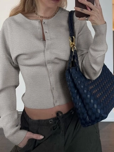 Détail du cardigan gris en maille à manches longues avec boutons sur le devant