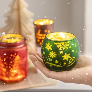 Frosted glass Christmas candle holder with snowflake patterns and warm tea light