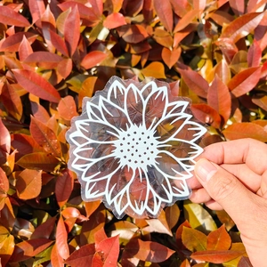Detail of sunflower prism window decal showing white line art on transparent static film