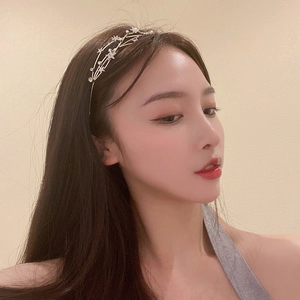 Side view of model wearing a tiered starry headband with rhinestone stars and thin metal bands