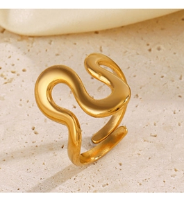 Macro detail of golden irregular wave ring showing minimalist S-shaped line design