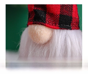 Close-up of Christmas gnome detail with red plaid hat and soft white fiber beard