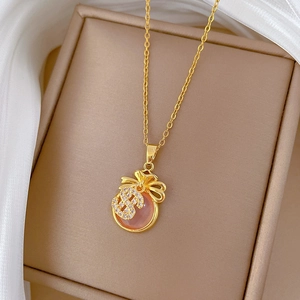 Elegant gold titanium necklace featuring a lucky bag pendant with pink and white crystals