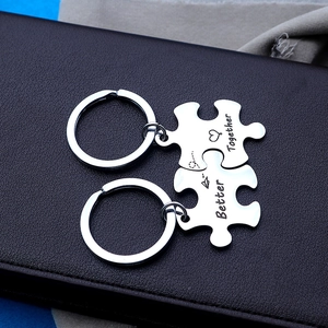 Detail of Better Together puzzle keychains in polished stainless steel with heart engraving