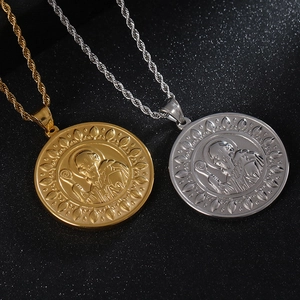 Close-up of gold and silver Saint Benedict medals with intricate embossed details