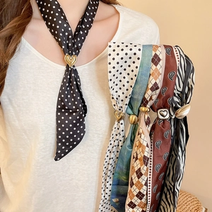 Detail showing vintage polka dot and paisley fabric scarves with metal heart buckles