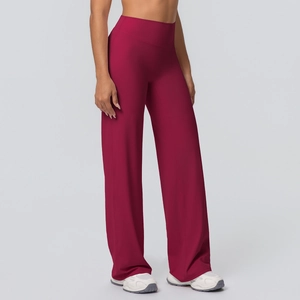 Macro detail of high-waisted wide-leg yoga pants in deep burgundy with premium matte texture