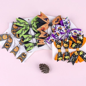Detail of Halloween hair clips featuring pumpkin, ghost and bat motifs on ribbon bows