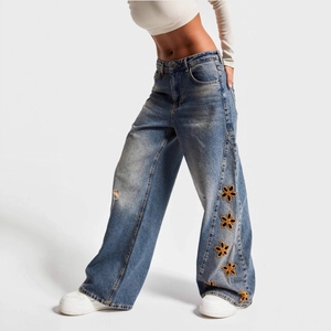 Women high waisted wide leg blue jeans with floral embroidery and distressed details