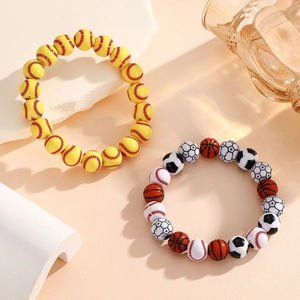 Macro view showing sports theme beads with soccer, basketball, and baseball textures