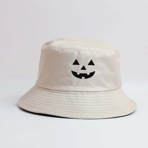 Detailed close-up of beige cotton bucket hat featuring a black Halloween pumpkin embroidery