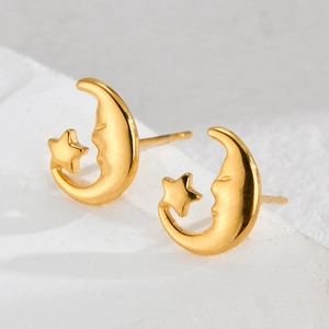 Polished 18K gold stainless steel star and moon earrings on a white stone base