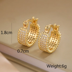Macro shot of gold-plated hoop earrings with white zircon pave and beaded edge design