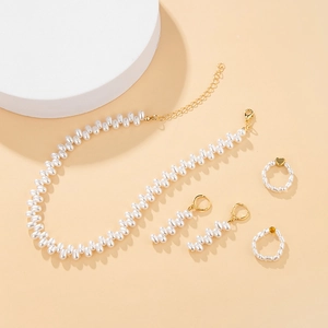 Detailed set of irregular pearl necklace, earrings, and heart rings in gold finish