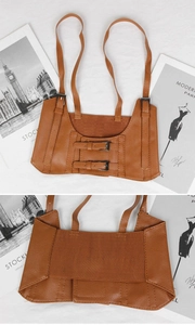Detail of brown PU leather corset belt with double metal buckles and elastic band back