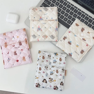 Detailed view of quilted cotton sanitary pouches with cute elephant and bear patterns