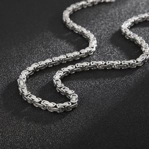 Detailed close-up of a silver stainless steel flat Byzantine chain necklace for men