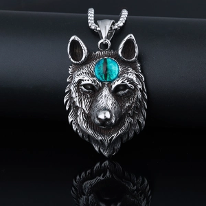 Detailed view of wolf head pendant with green bead inlay on vintage stainless steel chain