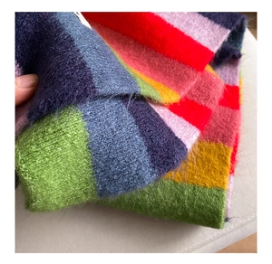 Close-up of rainbow striped mohair knit scarf showing soft texture and vibrant colors