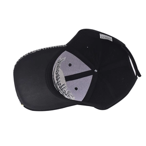 Detail view of the black baseball cap interior showing embroidery, stitching and care label