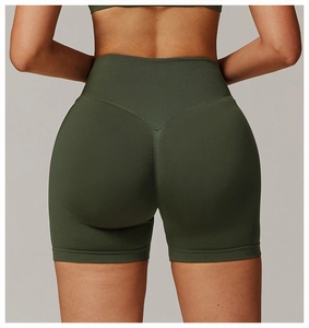 Detail view of seamless high-waist yoga shorts showing the V-shape lifting seam and knit texture