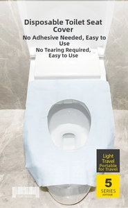 Detail of waterproof light blue disposable toilet seat cover in a bathroom setting