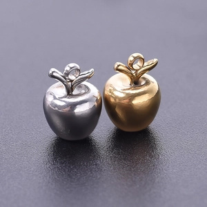 Macro view of gold and silver apple pendants in 304 stainless steel for DIY jewelry crafts