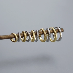 Detailed view of gold and silver S925 sterling silver hoop earrings in various sizes