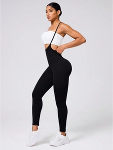Side view of black high-waisted yoga jumpsuit with slim straps for sports shaping
