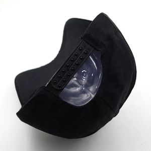 Detail view of the adjustable snapback closure on a black cotton baseball cap
