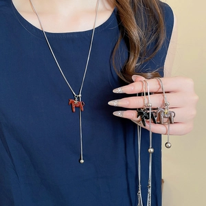 Three color pony charms necklaces on model showing red black and silver horseshoe styles
