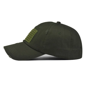 Detail view of olive green washed cotton baseball cap with embroidered flag and distressed edges