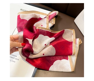 Detail of red and cream mulberry silk scarf featuring 3D floral pattern and hand-rolled edges