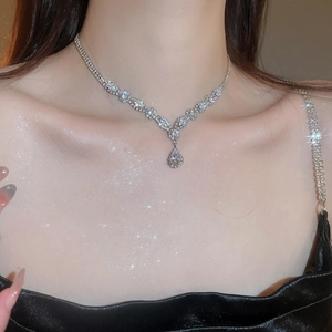 Detail shot of a silver Y-shaped zircon water drop pendant necklace on a model collarbone