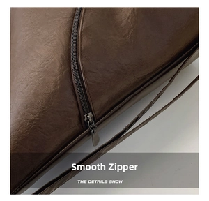 Detail shot of smooth metal zipper and premium brown faux leather texture on the bag